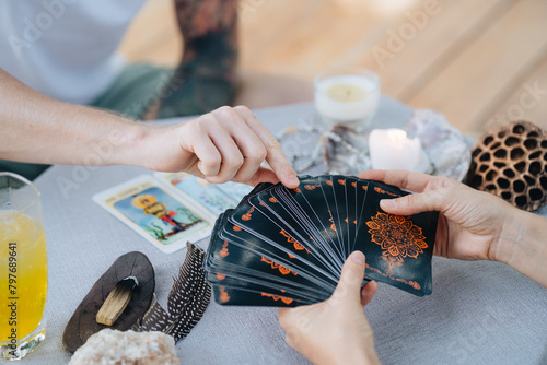 A woman is making tarot layout on the table
