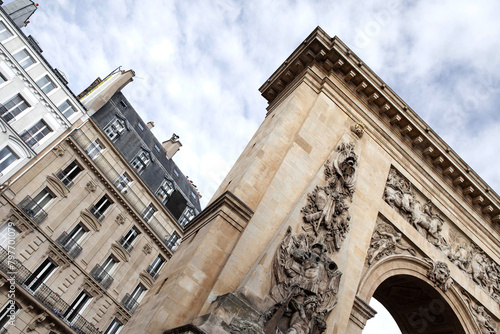 Buildingss and monument at Porte Saint Denis corner in Paris photo