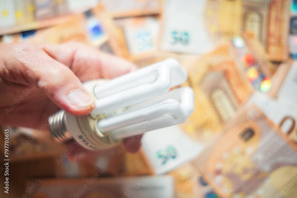 hand holding light bulb energy efficiency saving bills money hand holding light bulb energy efficiency saving bills money