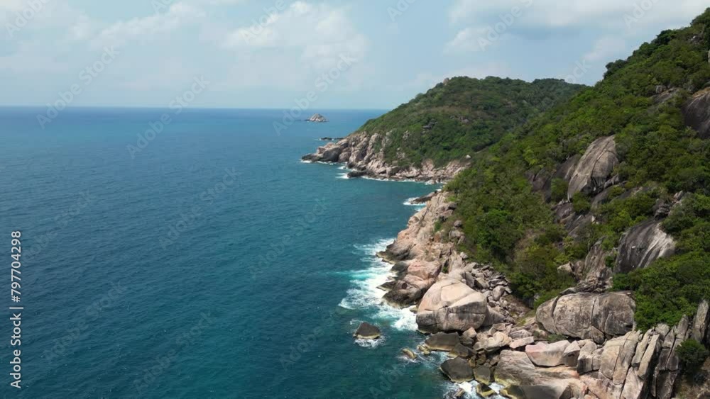 Forward aerial push in over green cliffs and ocean on tropical island Forward aerial push in over green cliffs and ocean on tropical island