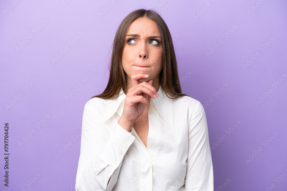 Young caucasian woman isolated on purple background having doubts and thinking Young caucasian woman isolated on purple background having doubts and thinking