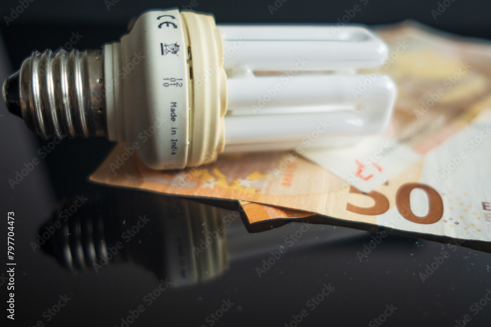 Light bulb with 50 euro note bills , Increase in electricity tariffs Light bulb with 50 euro note bills , Increase in electricity tariffs