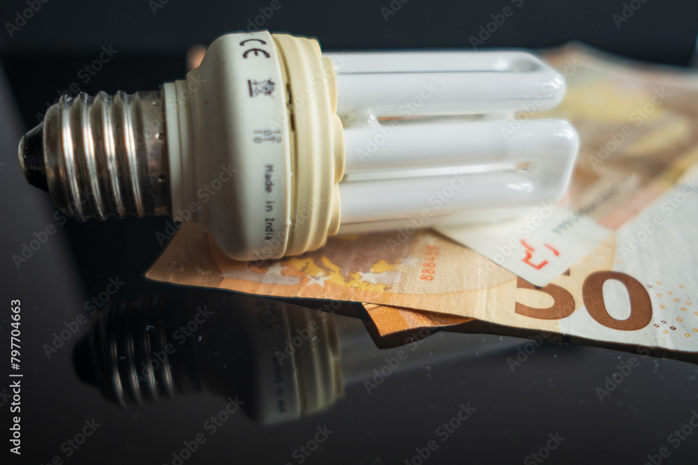 Light bulb with 50 euro note bills , Increase in electricity tariffs Light bulb with 50 euro note bills , Increase in electricity tariffs