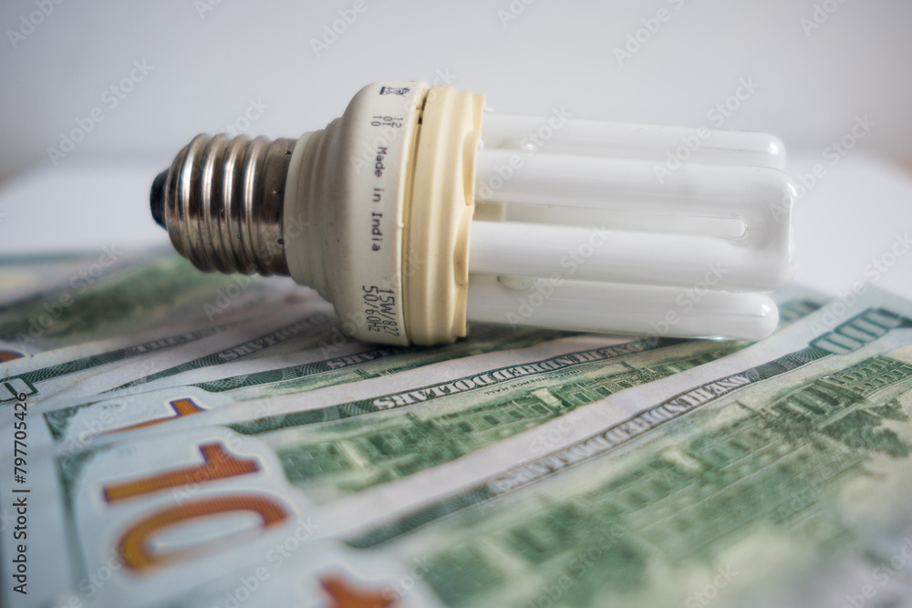 Light bulb with 100 usd note bills , Increase in electricity tariffs Light bulb with 100 usd note bills , Increase in electricity tariffs