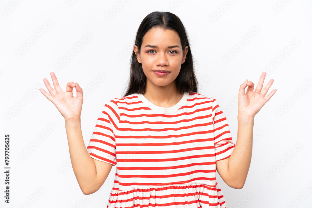 Young Colombian woman isolated on white background in zen pose Young Colombian woman isolated on white background in zen pose