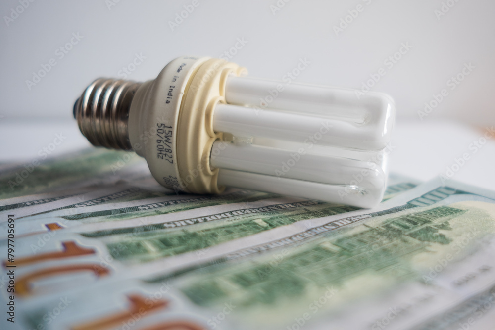 Light bulb with 100 usd note bills , Increase in electricity tariffs Light bulb with 100 usd note bills , Increase in electricity tariffs