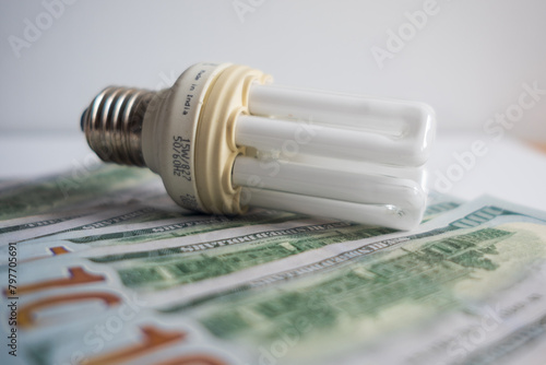 Light bulb with 100 usd note bills , Increase in electricity tariffs