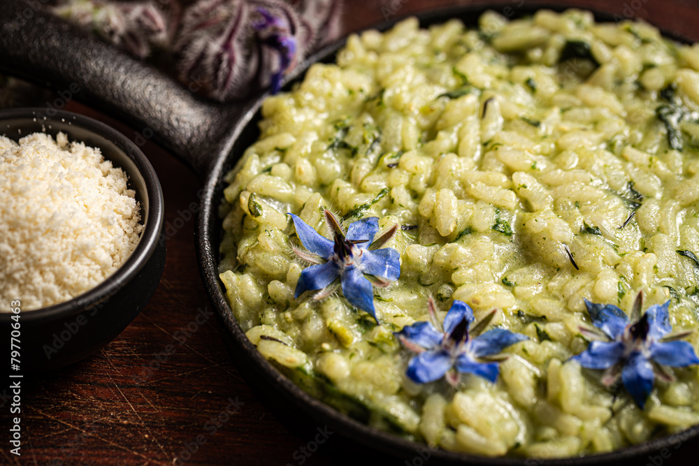 Indulgent risotto elevated by fragrant borage leaves.