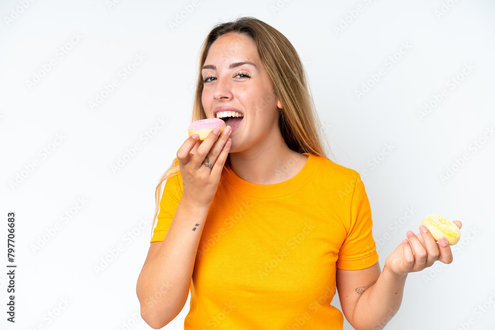Young caucasian woman isolated on white background eating a donut Young caucasian woman isolated on white background eating a donut