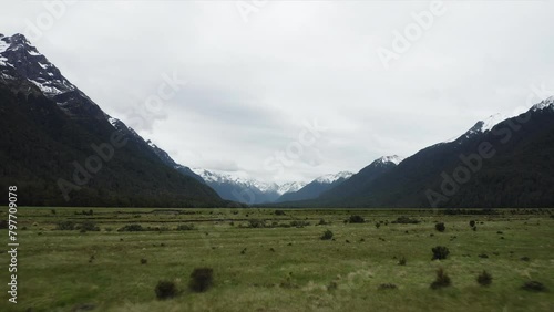 Racing over the flatlands of Eglinton Valley towards snow covered mountains, New Zealand photo