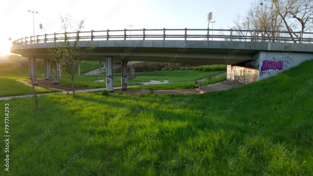 Urban Green Park Below Highway intersection, FPV Drone fly Feeway, Sunny Skyline background Urban Green Park Below Highway intersection, FPV Drone fly Feeway, Sunny Skyline background