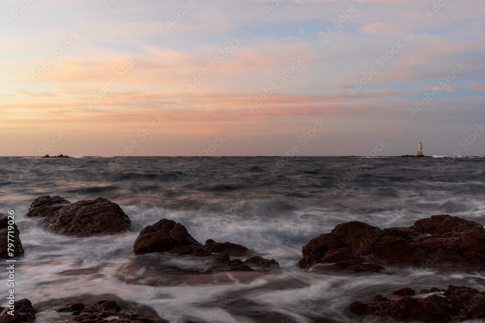 view of the Mangiabarche Lighthouse at sunrise on Sardinia view of the Mangiabarche Lighthouse at sunrise on Sardinia