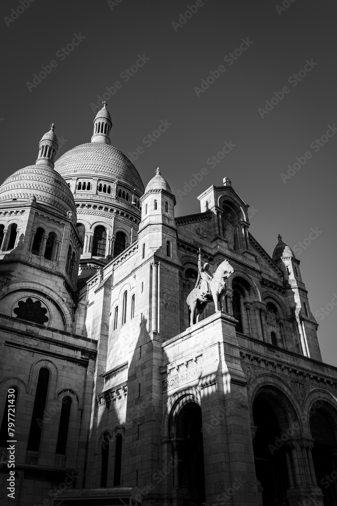 Black and white evening photo of the sacre coeur paris. 