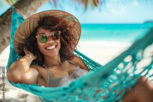 Joyful woman lounging in beach hammock © HASAN