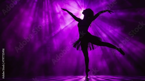 Dancer silhouette against deep purple spotlight © rookielion