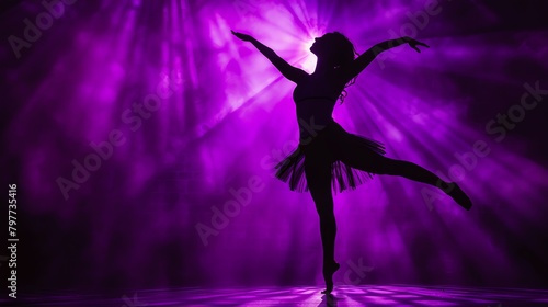 Dancer silhouette against deep purple spotlight