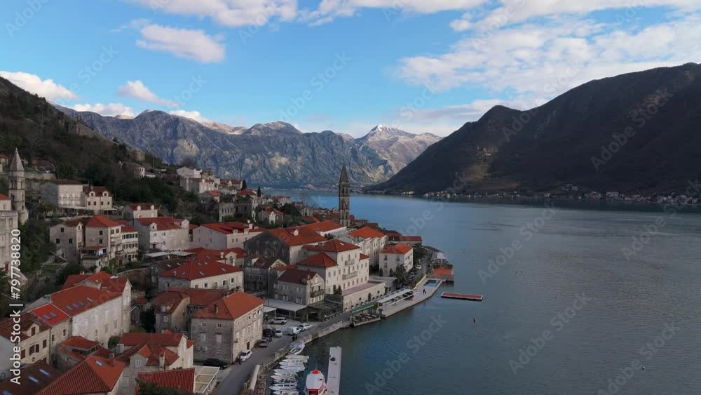 4K drone shot captures the charming town of Perast, Montenegro, with a beautiful view of Saint Nicholas Church, the UNESCO-listed Bay of Kotor, and mountains in the background 4K drone shot captures the charming town of Perast, Montenegro, with a beautiful view of Saint Nicholas Church, the UNESCO-listed Bay of Kotor, and mountains in the background