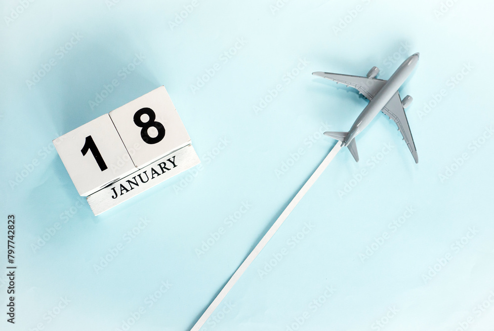 January calendar with number 18. Top view of a calendar with a flying passenger plane. Planner for the year by date of the day. Copy space. January calendar with number 18. Top view of a calendar with a flying passenger plane. Planner for the year by date of the day. Copy space.