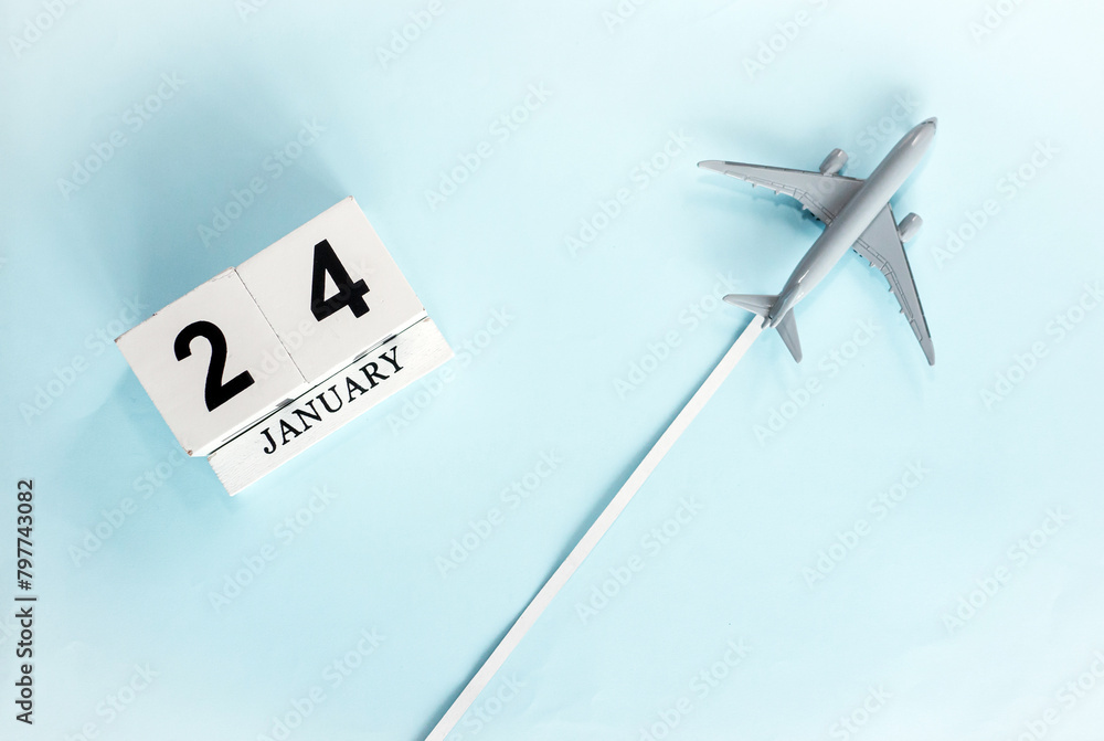 January calendar with number 24. Top view of a calendar with a flying passenger plane. Planner for the year by date of the day. Copy space. January calendar with number 24. Top view of a calendar with a flying passenger plane. Planner for the year by date of the day. Copy space.
