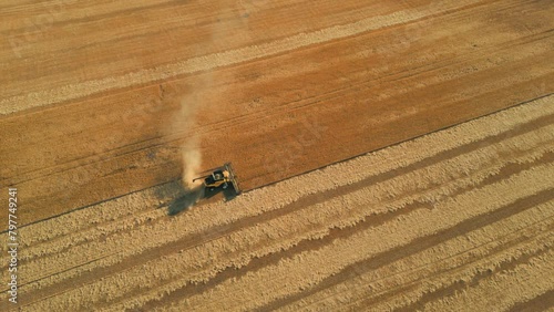 drone shot around combine harvester in a wheat field revealing the stirling range national park and the landscape in the background, western australia photo