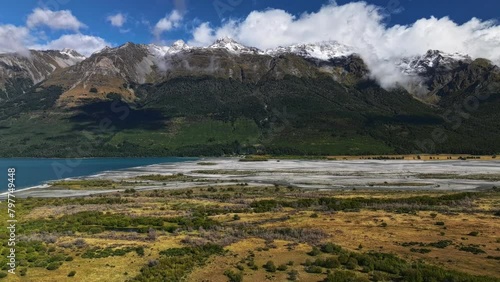 Clouds rise and dissapear into air casting shadow across lowlands of South Island New Zealand photo