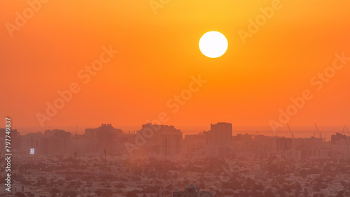 Sunset in Ajman aerial view from rooftop timelapse. United Arab Emirates. photo