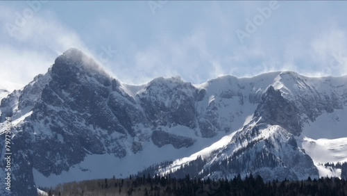 Timelapse of San Juan Mountains in winter as spindrift blows from summit in high winds - Telluride, Colorado photo