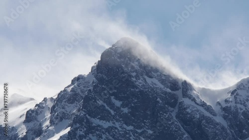 Timelapse in the Rocky Mountains in winter as spindrift blows from summit in high winds - Telluride, Colorado photo