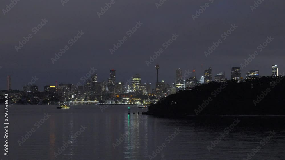 Slow reveal of Sydney Australia. Night Time view of city. Two boats sailing away from city Slow reveal of Sydney Australia. Night Time view of city. Two boats sailing away from city