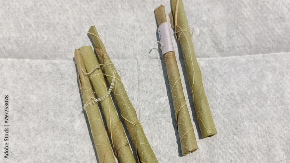 beadies tobacco Bidi or Beedi, A beedi is a thin cigarette or mini-cigar filled with  tobacco flake and commonly wrapped in a tendu or Piliostigma racemosum leaf  tied with a string or adhesive, bidi isolated
