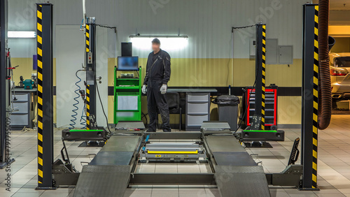 Car on stand with sensors on wheels for wheels alignment camber check in workshop of Service station timelapse. photo