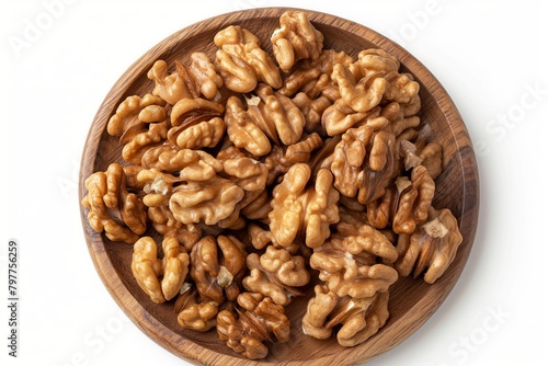 A plate of walnuts is on a wooden table