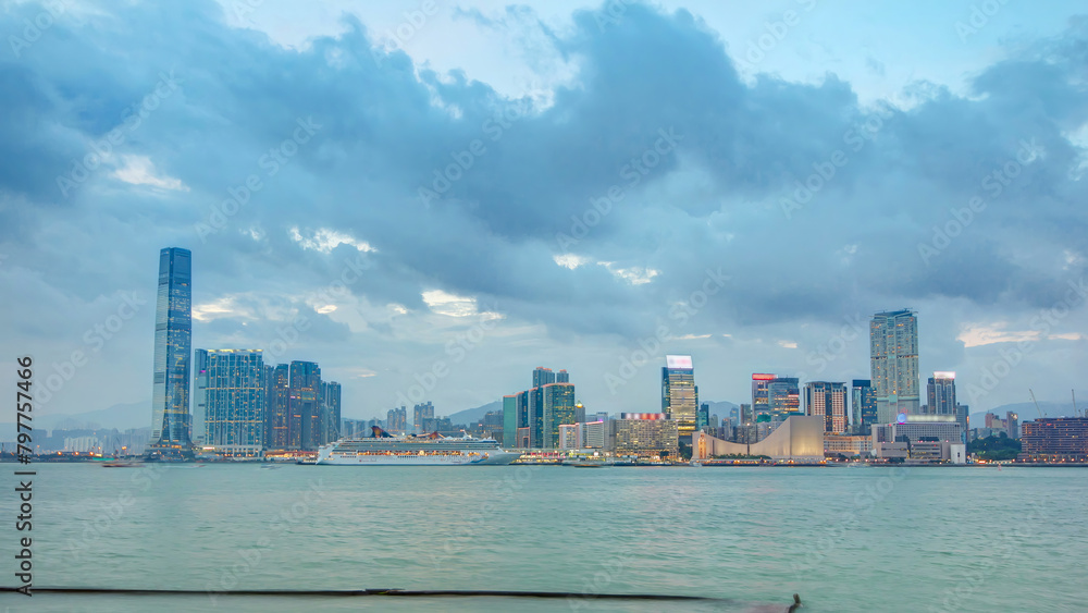 Skyline panorama timelapse day to night with International Commerce Centre in West Kowloon, Hong Kong.