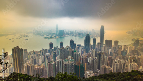 The famous view of Hong Kong from Victoria Peak timelapse. Sunrise with colorful clouds over Kowloon Bay.