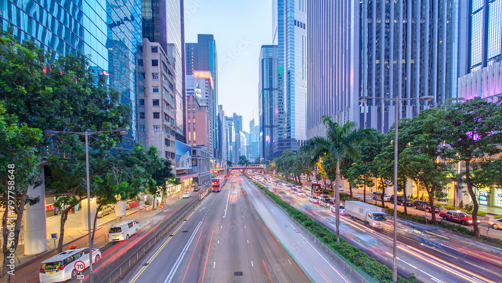 Hong Kong street with busy traffic and skyscraper office at dusk day to night timelapse. Hong Kong street with busy traffic and skyscraper office at dusk day to night timelapse.