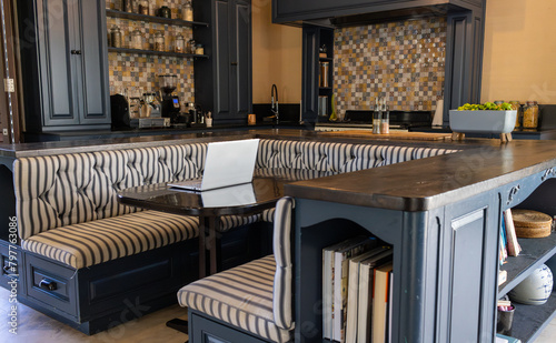 A modern kitchen with striped bench seating and large island photo