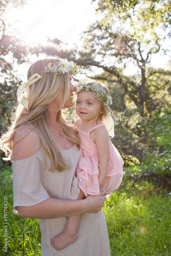 Mother and daughter share a tender moment in nature Mother and daughter share a tender moment in nature