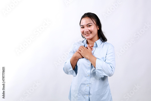 Touched pleased with a compliment cheerful happy asian young woman isolated in white background. Praise recommendation, sweet heart