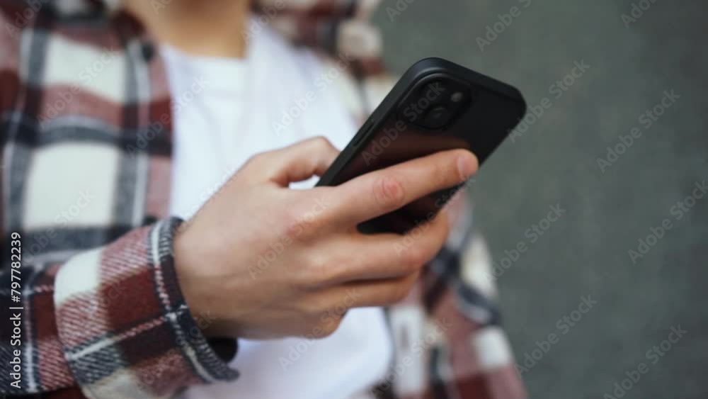 The phone is in the hands of a young man.
The guy looks at the phone.
A man clicks on his phone The phone is in the hands of a young man.
The guy looks at the phone.
A man clicks on his phone