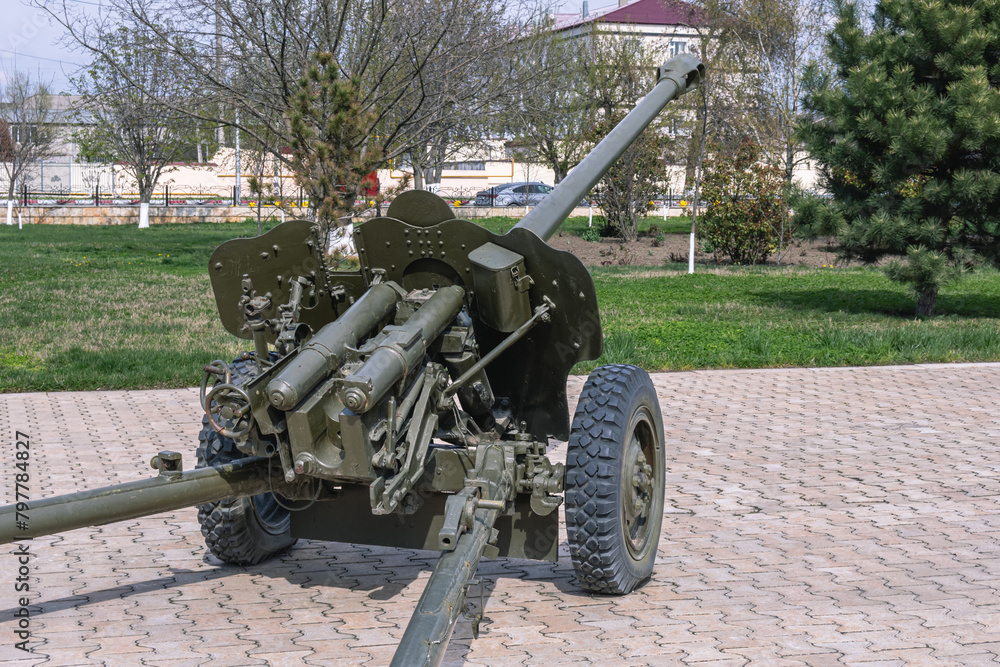 An artillery piece. Army weapons. The barrel of the cannon. Towed artillery piece on wheels. A weapon for dealing damage at a great distance during combat operations. An artillery piece. Army weapons. The barrel of the cannon. Towed artillery piece on wheels. A weapon for dealing damage at a great distance during combat operations.
