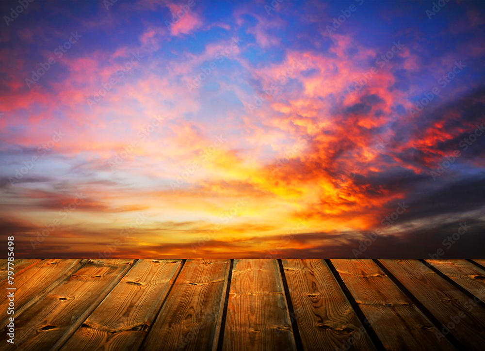 Wooden table and purple, blue, orange sky background with sunset light. Wooden table and purple, blue, orange sky background with sunset light.