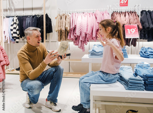 Father and Daughter Trying on Shoes Together at a Retail Store