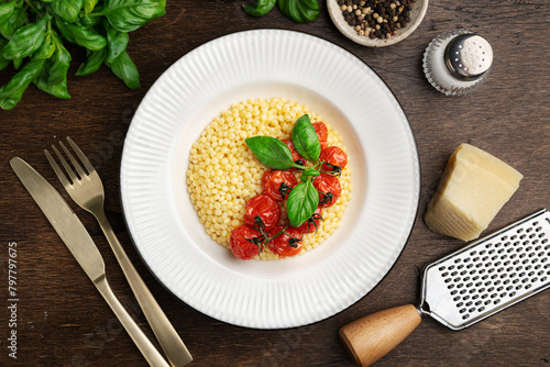 Pasta ptitim, Israeli couscous, in a white plate, top view