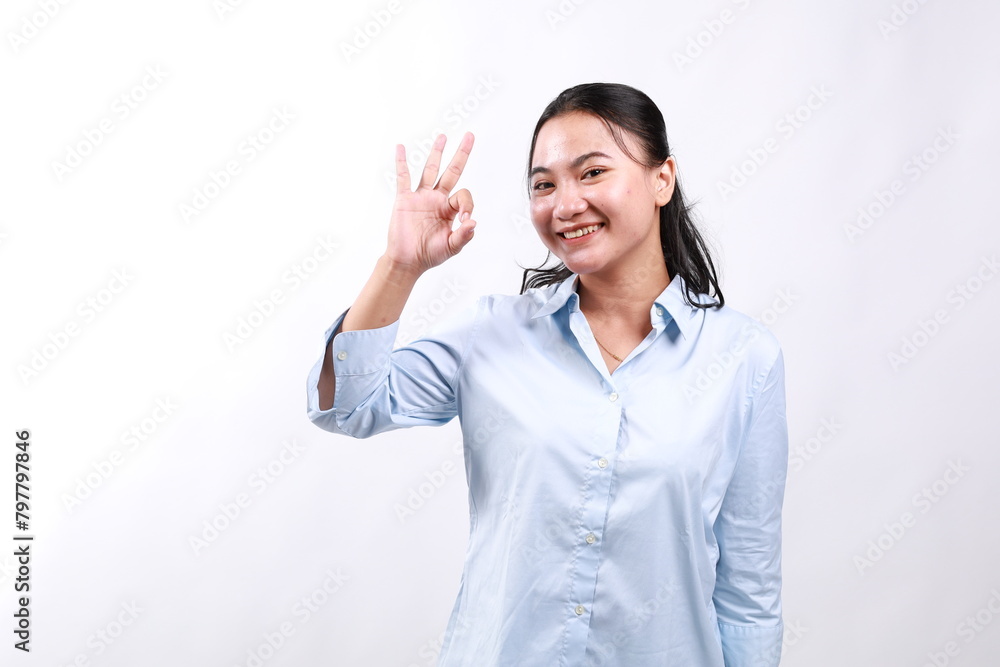 Smiling asian woman showing okay, Very good with satisfied face expression, praise and compliment great job, pleased by smth, standing over white background Smiling asian woman showing okay, Very good with satisfied face expression, praise and compliment great job, pleased by smth, standing over white background