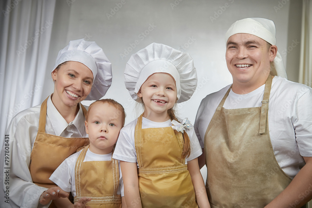 Cute oriental family with mother, father, daughter, son cooking in kitchen on Ramadan, Kurban-Bairam, Eid al-Adha. Funny family at photo shoot. Easter Cute oriental family with mother, father, daughter, son cooking in kitchen on Ramadan, Kurban-Bairam, Eid al-Adha. Funny family at photo shoot. Easter