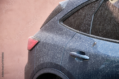 Car covered with windblown sand and dust from Sahara to Europe, after rain.