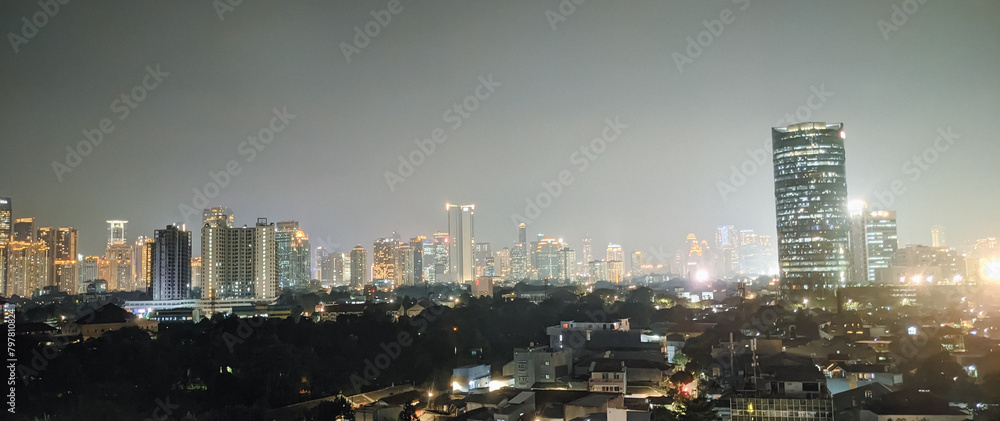 Sensational night view of Jakarta skyline at night. Horizontal banner flat of panoramic photography. Virtual background concept
