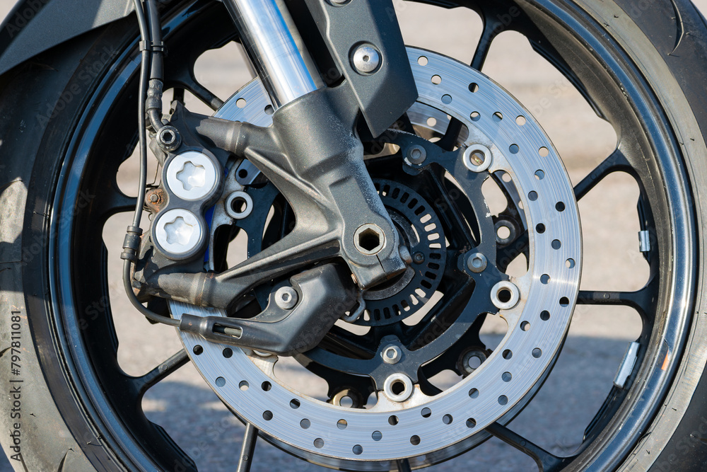 brake disc of a sports motorcycle close-up. Front wheel. The concept of heating during braking. Close-up brake disc of a sports motorcycle close-up. Front wheel. The concept of heating during braking. Close-up