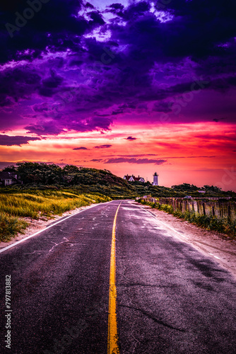 Saturated vibrant ethereal sunset with purple and red cloudscape over the coastal road on Cape Cod, Massachusetts, USA
