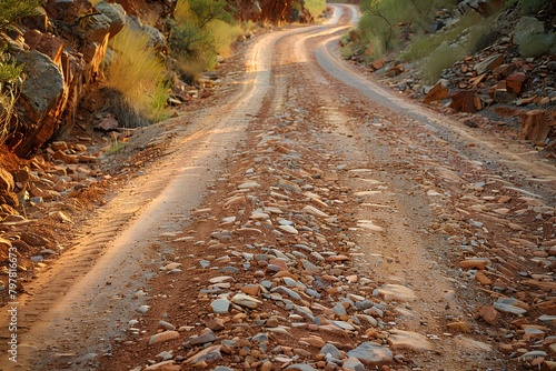 A dirt road with rocks and grass on both sides of it and a rock wall on the other side liminal